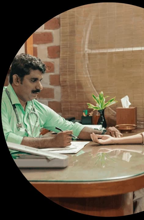 Kairali physician assessing a patient at consultation