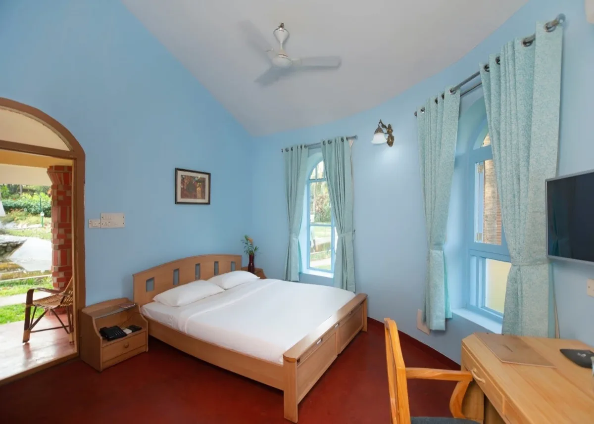 Blauwe slaapkamer van de Deluxe Villa met uitzicht op de tuin