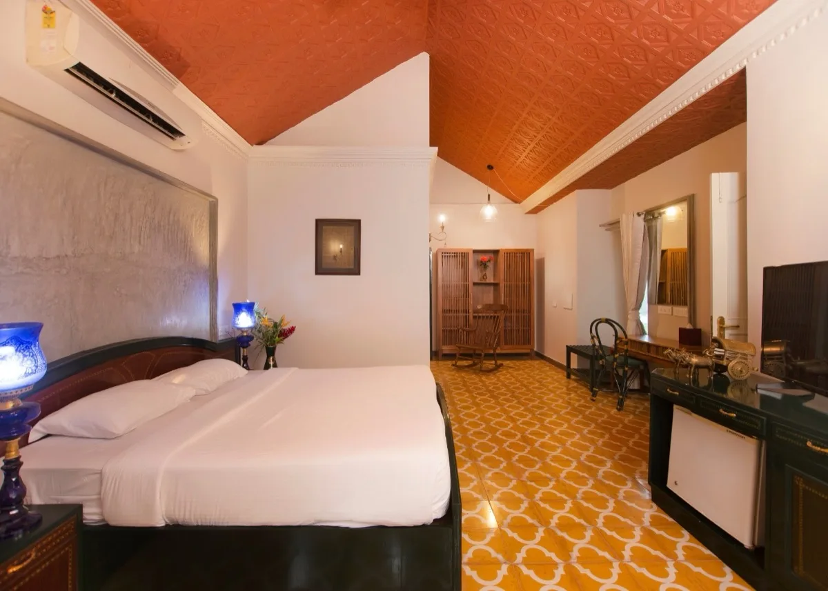 Camera da letto della suite con scrivania e pavimento dorato